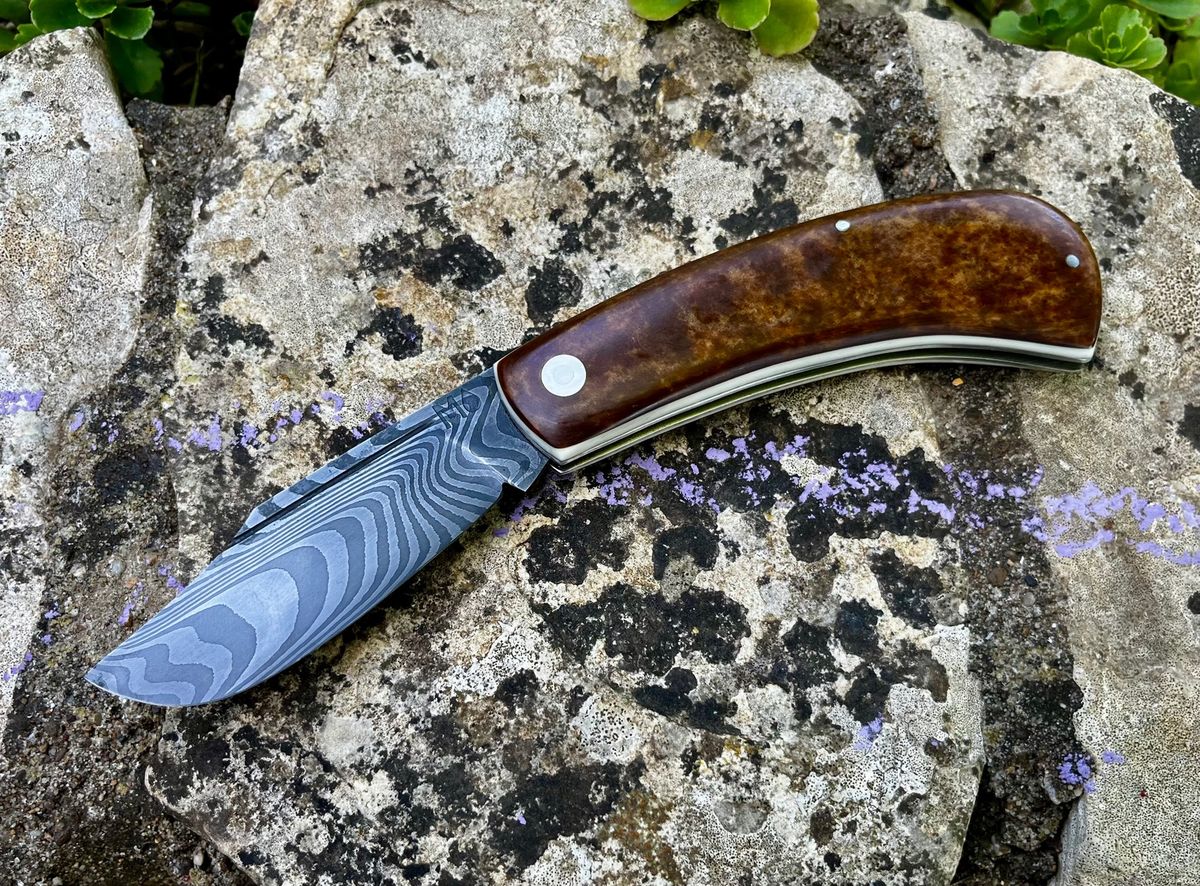 Chunky trapper slipjoint open with damascus blade